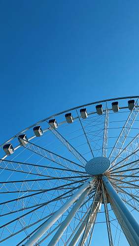 blue white Ferris wheel under blue sky ferris wheel